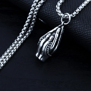 Macro view of silver praying hands pendant on sturdy stainless steel box chain necklace