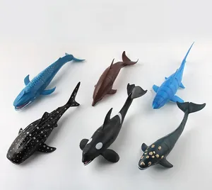 Detailed overhead view of six realistic plastic ocean animal models including shark and whale