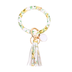 Close-up of a floral print leather tassel keychain with a golden metal spring ring