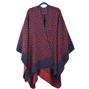 Detail of navy blue knitted shawl featuring a red leopard print and soft texture