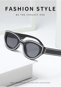 Close-up of retro cat-eye sunglasses with black frames and white outline detail