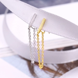 Macro detail of S925 sterling silver chain drop earrings in gold and silver finish
