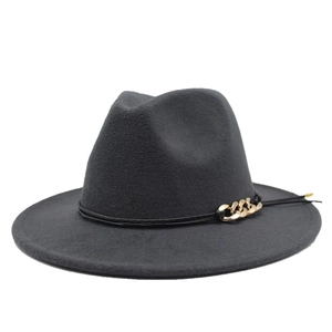 Dettaglio di un cappello fedora grigio scuro con cinturino in pelle e catena dorata