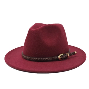 Detail of burgundy fedora hat with brown braided leather band and gold buckle accent