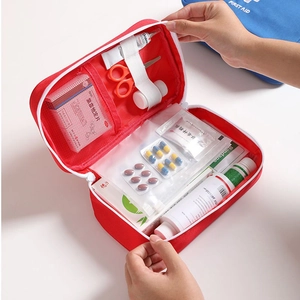 Portable red Oxford cloth first aid kit with internal mesh pockets and elastic straps