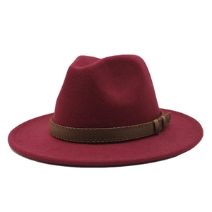 Detail of burgundy wool fedora hat with a brown leather decorative band and zigzag stitching