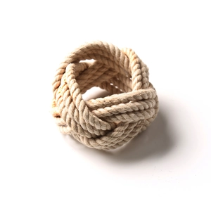 Handwoven beige rattan rope napkin ring with natural fiber texture on white background