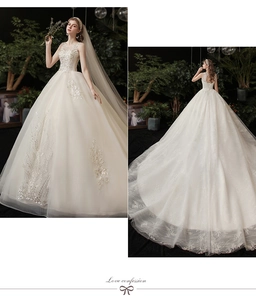 Close-up of ivory wedding dress with floral lace applique and a luxurious long train