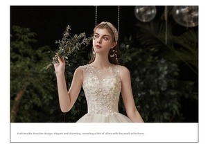 Close-up of white wedding dress featuring delicate lace embroidery and sequin beadwork
