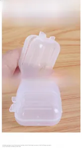 Close-up of mini transparent plastic storage box with secure latch and non-slip texture