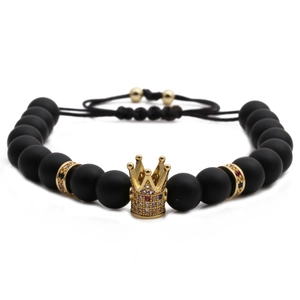 Adjustable black matte bead bracelet featuring a golden micro-pave cubic zirconia crown