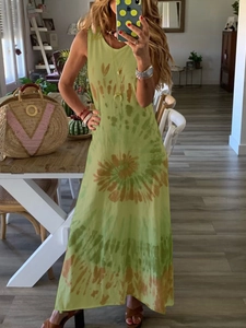 Detail of a long sleeveless round neck dress with green and yellow tie-dye pattern