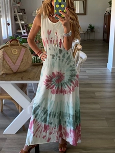 Detail of red and teal spiral tie-dye pattern on a sleeveless bohemian maxi beach dress