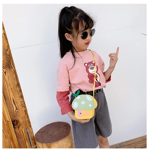 Detail of mushroom crossbody bag paired with strawberry bear print kids outfit
