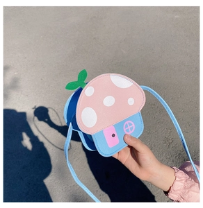 Detail shot of a creative mushroom house shaped crossbody bag for kids in blue and pink