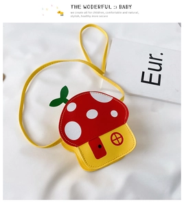 Close-up of mushroom-shaped kids crossbody bag in red and yellow on a soft white texture