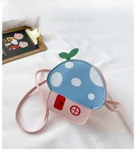 Top view of a cartoon mushroom house crossbody bag with blue polka dot flap and pink base