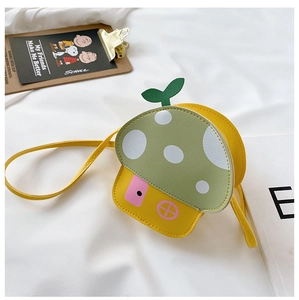 Close-up of yellow mushroom-shaped toddler crossbody bag with green polka dot roof