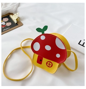 Detail of mushroom-shaped kids crossbody bag with red roof and yellow PU leather body