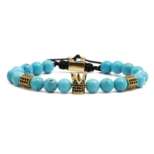 Blue turquoise bead bracelet with a gold crown charm on adjustable black cord