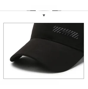 Detail of black cotton baseball cap showing sturdy twill fabric and ALE metal logo