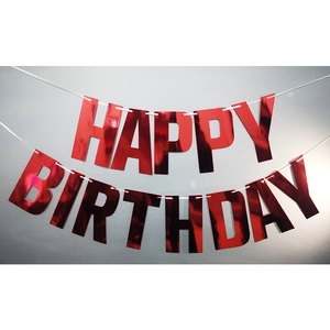 Close-up of shiny red metallic Happy Birthday banner letters with laser effect