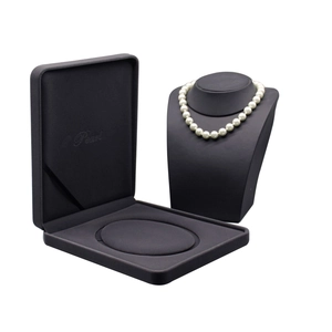 Dark grey velvet jewelry box and display stand for pearl necklaces in a minimalist style
