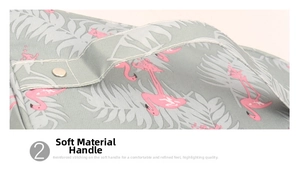 Detail of reinforced strap handle with metal rivets on flamingo print toiletry bag