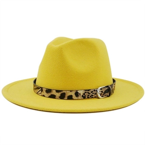 Close-up of bright yellow wool fedora hat featuring leopard print belt with silver buckle