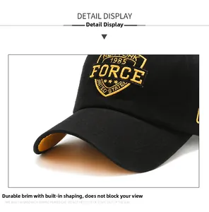 Close-up of black cotton baseball cap with gold FORCE embroidery and reinforced brim