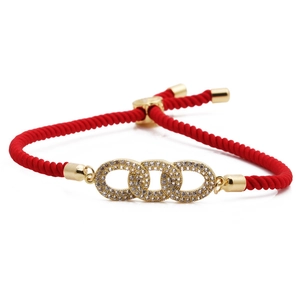 Adjustable red woven infinity bracelet with gold interlocking rings and cubic zirconia