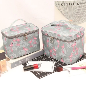 Detail of portable waterproof cosmetic bags featuring pink flamingo and leaf patterns
