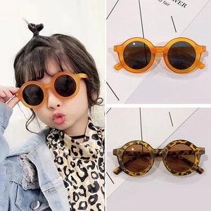 Detailed views of kids round leopard and orange sunglasses on a model and flat layout