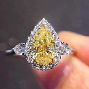 Pear cut yellow zircon ring with halo diamonds and silver-tone band for women