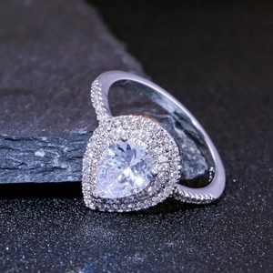 Elegant pear cut zircon ring with double halo setting and shimmering side stone pavé