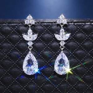 Elegant silver teardrop earrings featuring pear-cut zircon and floral leaf design