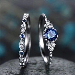 Vintage silver ring set featuring deep blue zircon and white round crystals on black stone