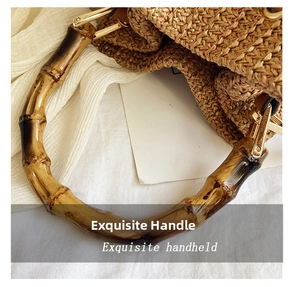 Detailed macro view of the bamboo top handle and gold metal buckle on woven straw bag