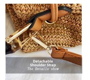 Detail of a straw bucket bag showing the removable shoulder strap with gold metal hooks