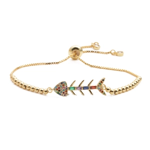 Adjustable golden bracelet with a zircon-inlaid fishbone charm in vibrant colors