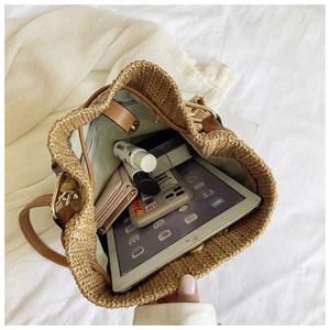 Interior view of the large capacity straw bucket bag showing iPad and essentials