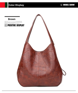Detailansicht der braunen Hobo-Tasche aus genarbtem Leder mit breitem Schulterriemen