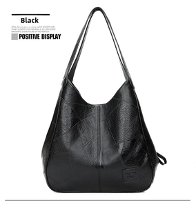 Detailansicht einer schwarzen Shopper-Tasche aus Kunstleder mit geometrischen Nähten