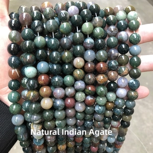 Macro shot of natural Indian agate beads showing unique multicolored mossy green textures