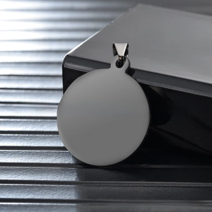 Macro detail of a blank circular stainless steel pet ID tag with a metal jump ring