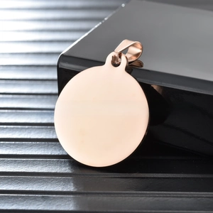 Macro shot of mirror-polished rose gold stainless steel round pet tag with hanging ring