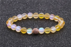 Frosted yellow moonstone bead bracelet with rose gold micro-pave charm on black background