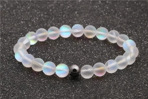 Moonstone and hematite beaded bracelet with aurora glass effect on dark textured surface