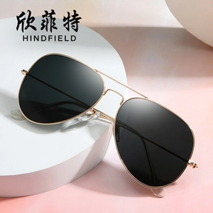 Classic gold metal aviator sunglasses with black polarized lenses on a white display