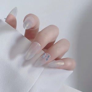 Detailed view of long almond aurora press-on nails with blue resin butterfly accents